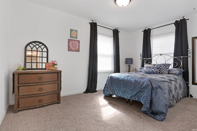 carpeted bedroom with baseboards and multiple windows