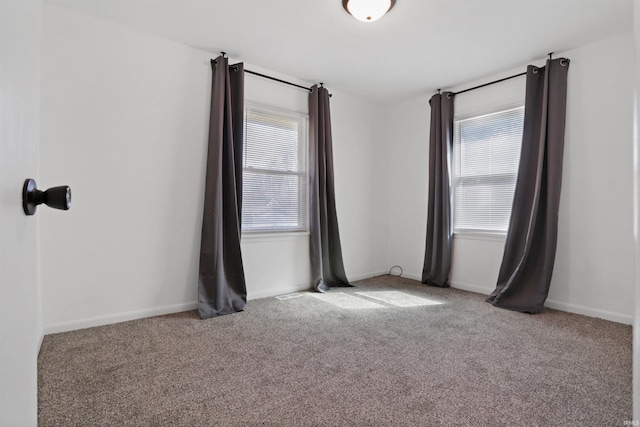 empty room with baseboards and carpet floors