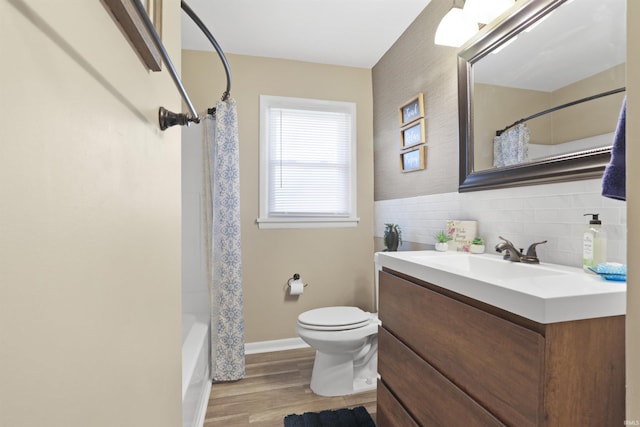 bathroom featuring shower / bath combo, toilet, vanity, and wood finished floors