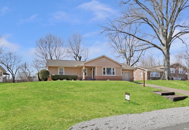 ranch-style house with brick siding, a front lawn, and an attached garage