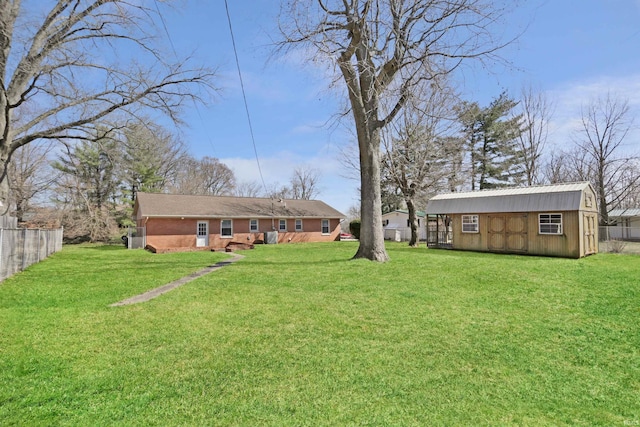 view of yard featuring an outdoor structure and fence