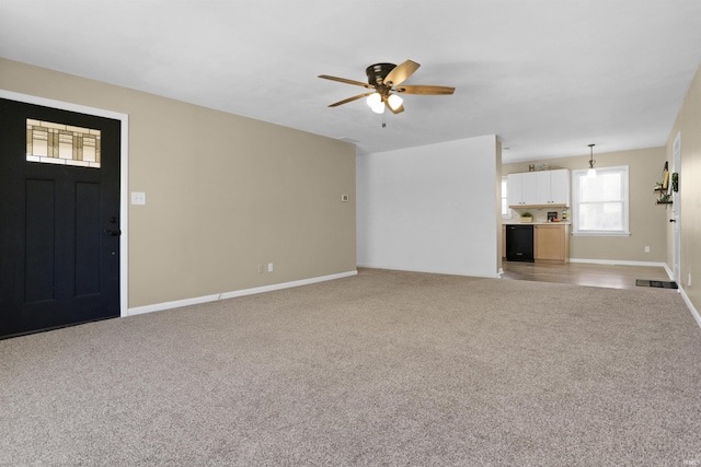 unfurnished living room featuring ceiling fan, baseboards, and light carpet