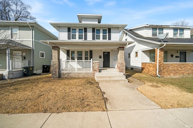 american foursquare style home featuring covered porch