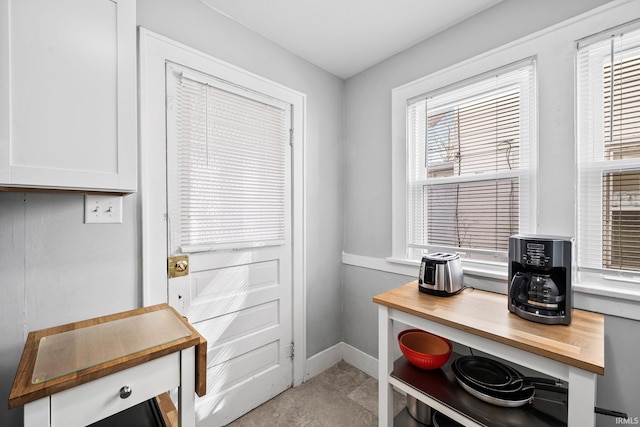 doorway featuring baseboards