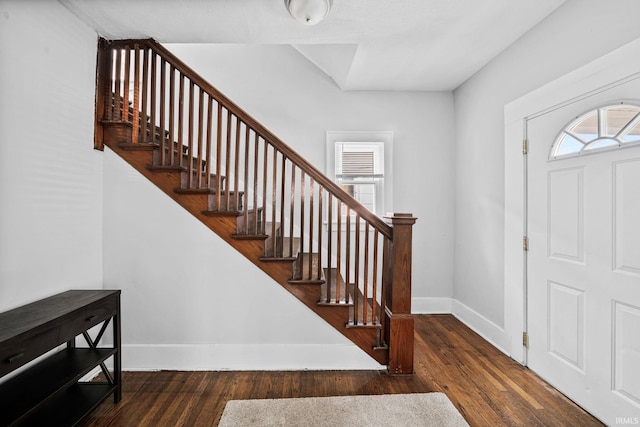 entryway featuring stairway, baseboards, and wood finished floors