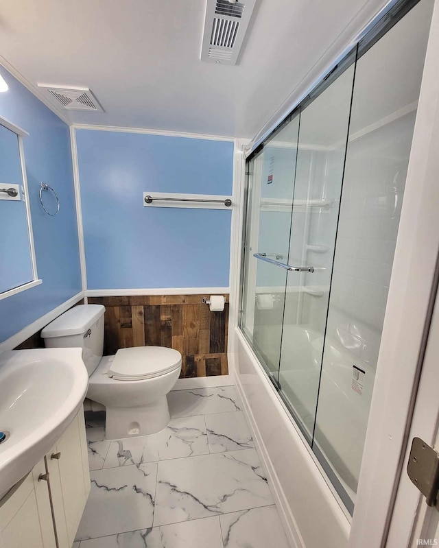 bathroom featuring toilet, visible vents, marble finish floor, and bath / shower combo with glass door