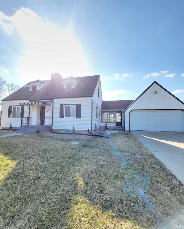 view of front of house with a front lawn, concrete driveway, and a garage