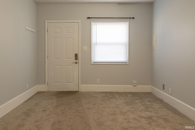 unfurnished room with carpet flooring and baseboards