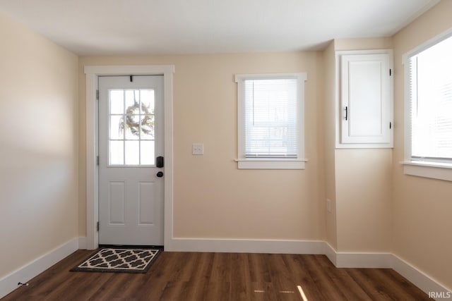 entryway with dark wood finished floors and baseboards