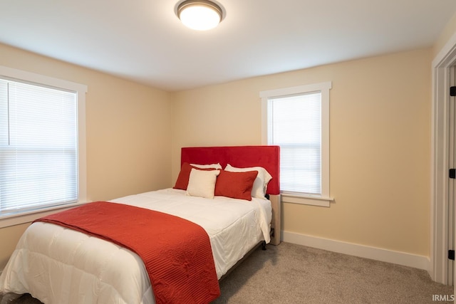 carpeted bedroom with baseboards