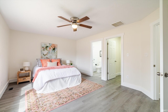 bedroom with light wood-type flooring, visible vents, and baseboards