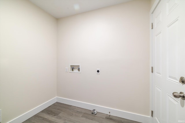 clothes washing area with washer hookup, wood finished floors, baseboards, hookup for an electric dryer, and laundry area