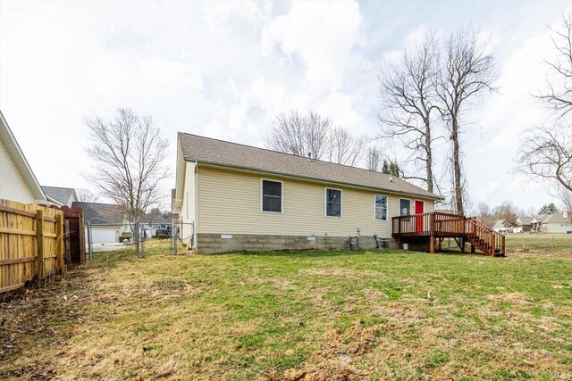 back of property with a deck, a gate, fence, a yard, and stairway