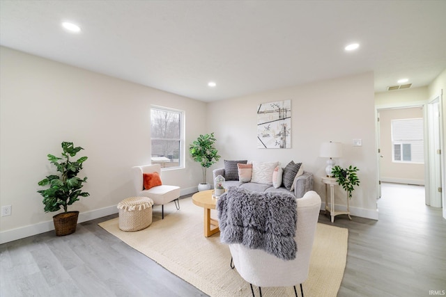 living area featuring recessed lighting, light wood-type flooring, and baseboards