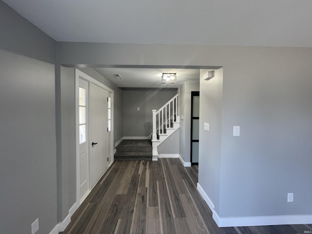 entrance foyer with stairway, baseboards, and dark wood-style flooring