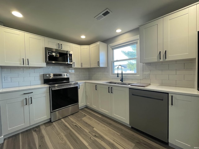 kitchen featuring a sink, visible vents, appliances with stainless steel finishes, and light countertops