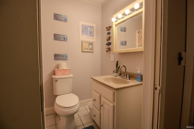 bathroom with tile patterned flooring, toilet, vanity, and baseboards