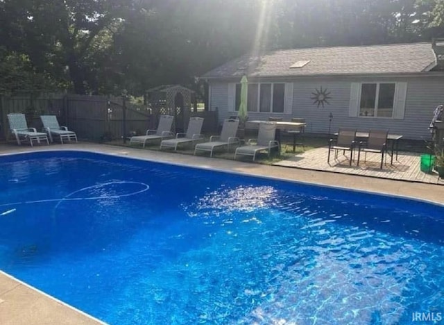 view of pool with a fenced in pool, a patio, and fence