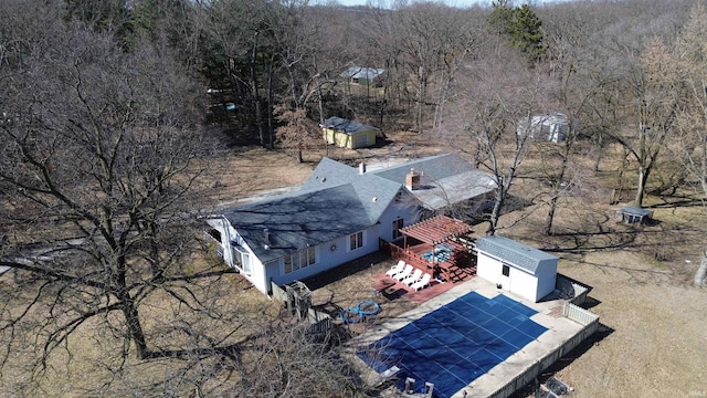 birds eye view of property with a view of trees