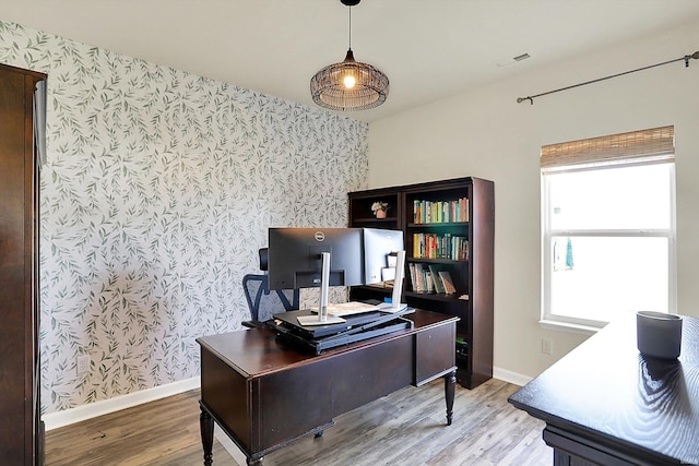 office featuring baseboards, light wood-style floors, and wallpapered walls