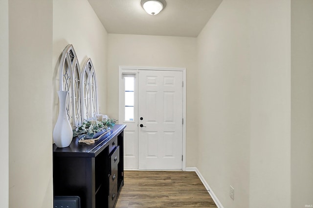 foyer entrance with baseboards and wood finished floors