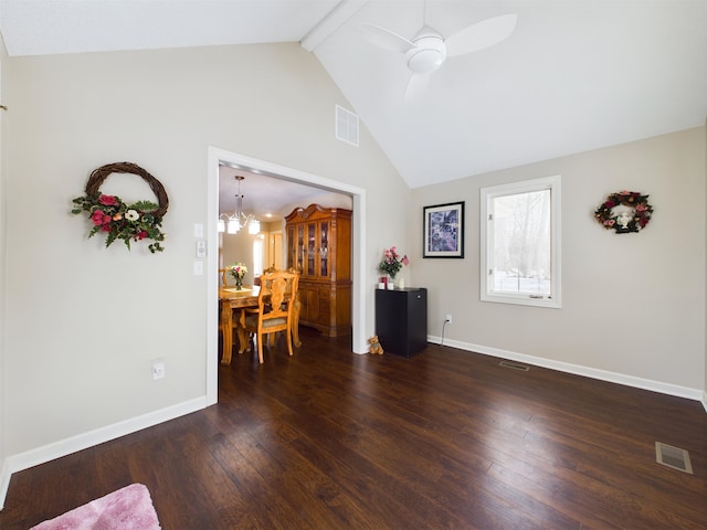 interior space featuring dark wood-type flooring, baseboards, visible vents, and beam ceiling