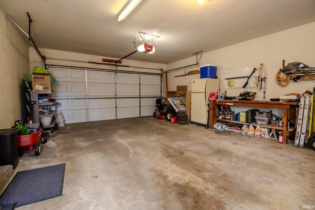 garage featuring a garage door opener and freestanding refrigerator