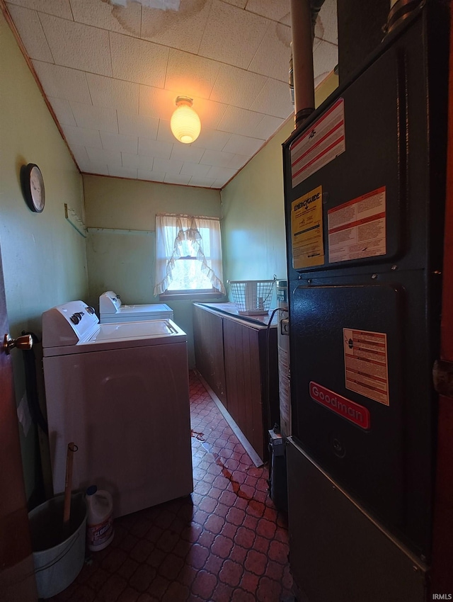 laundry room featuring heating unit, laundry area, and washer and dryer