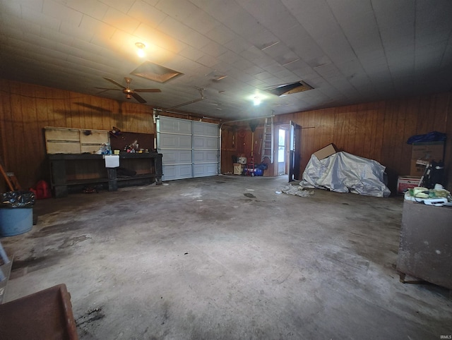 garage with wood walls and a ceiling fan