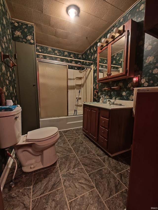 full bathroom with combined bath / shower with glass door, toilet, wallpapered walls, and vanity