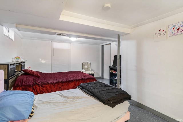 bedroom with baseboards and visible vents