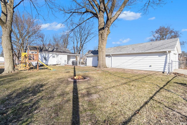 view of yard with a playground and fence