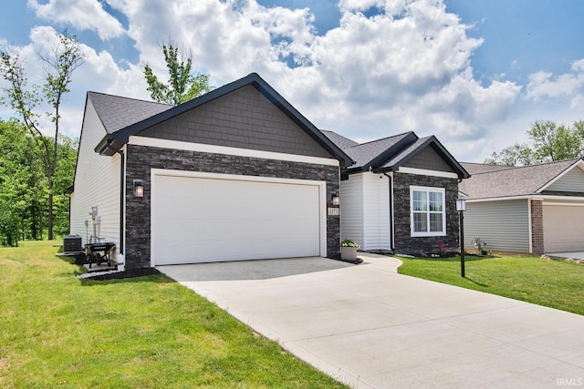 view of front of house with central air condition unit, driveway, a front lawn, stone siding, and an attached garage