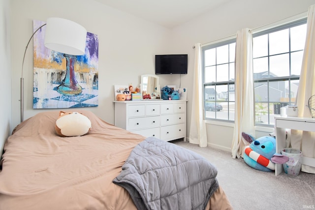 carpeted bedroom featuring baseboards