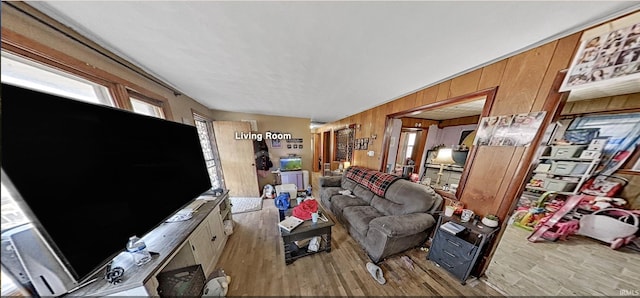 living area with wooden walls and wood finished floors