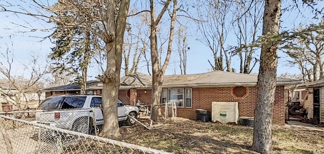 single story home featuring brick siding and fence