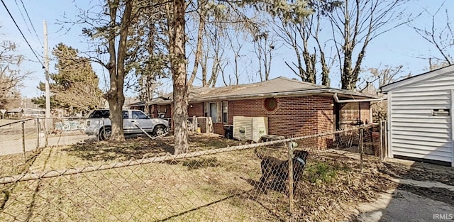 view of front of property featuring brick siding and fence