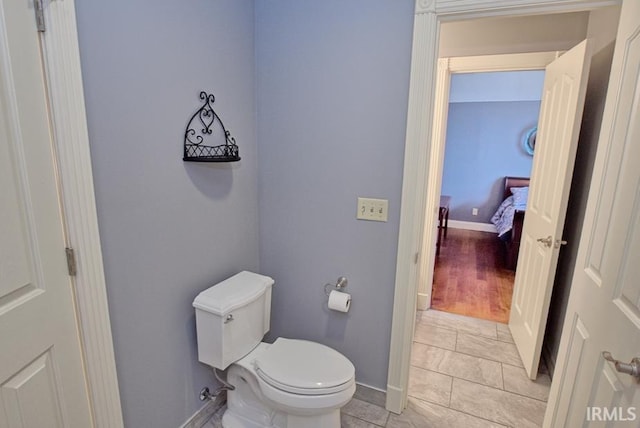 bathroom featuring toilet and baseboards