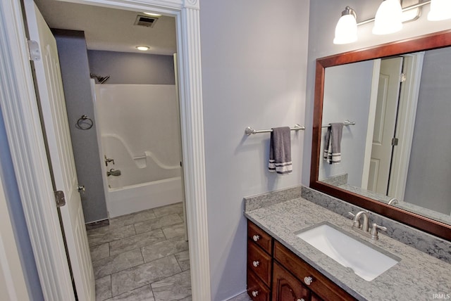 bathroom with visible vents, vanity, and bathtub / shower combination