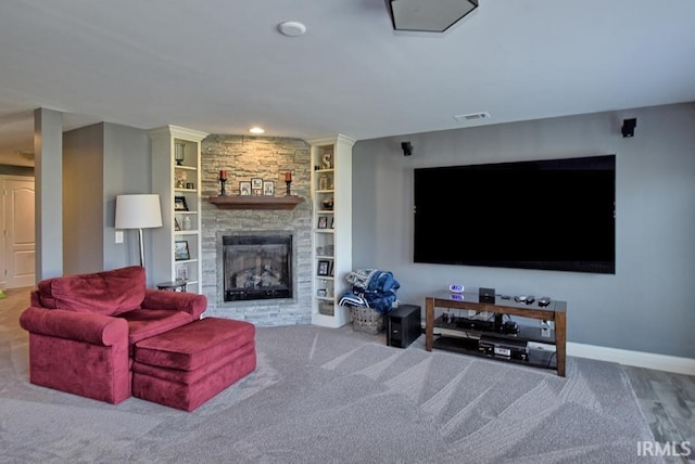 living area with visible vents, baseboards, built in features, recessed lighting, and a fireplace