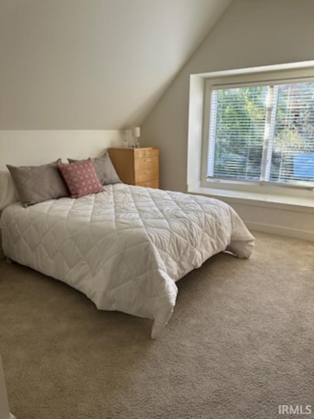 carpeted bedroom with vaulted ceiling