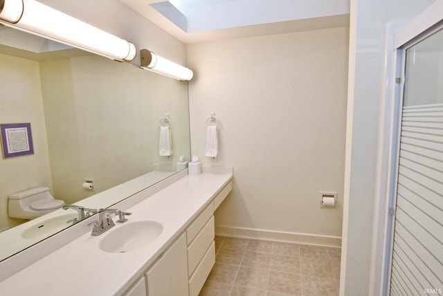 bathroom featuring vanity, baseboards, and tile patterned flooring