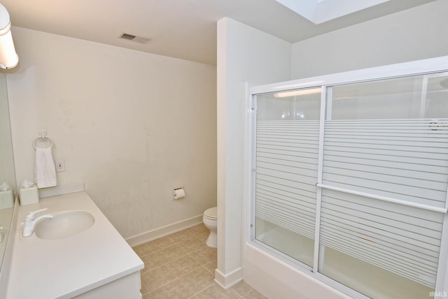 bathroom with tile patterned flooring, visible vents, toilet, a skylight, and vanity