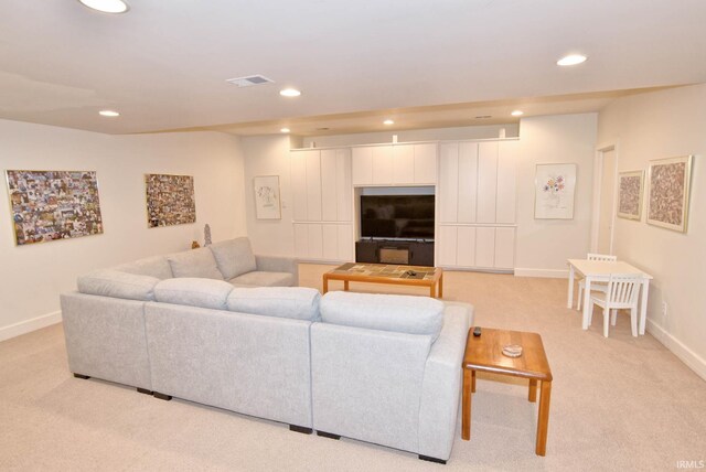 living room featuring light carpet, visible vents, recessed lighting, and baseboards