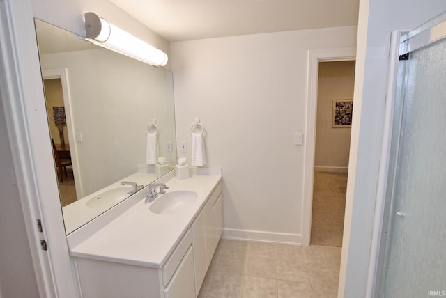 full bathroom with tile patterned floors, vanity, and baseboards