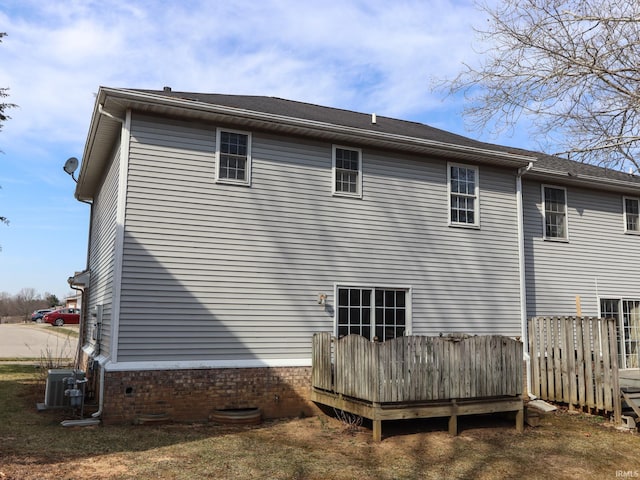 back of property featuring central AC unit and a deck