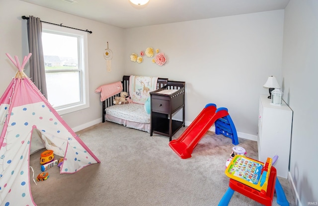 rec room with baseboards and carpet floors