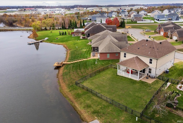 drone / aerial view featuring a residential view and a water view