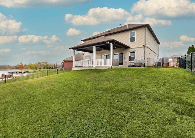 back of property featuring brick siding, a lawn, and a fenced backyard