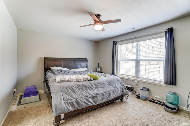 carpeted bedroom featuring visible vents, ceiling fan, and baseboards